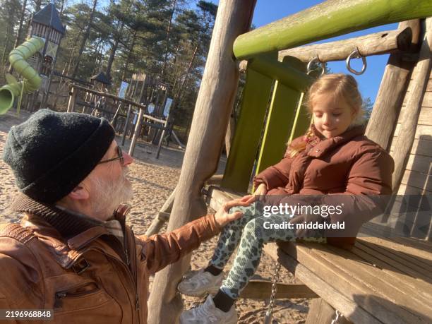 generation joy on the playground. - old playground stock pictures, royalty-free photos & images