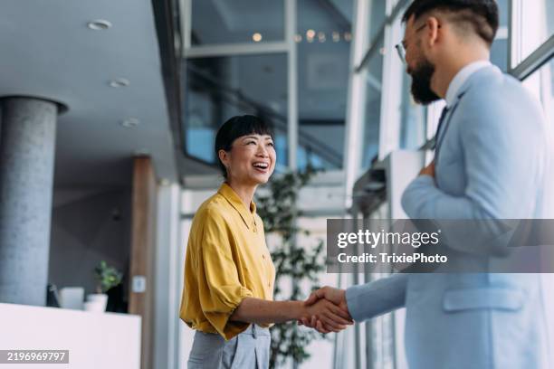 successful partnership. - two men shaking hands stock pictures, royalty-free photos & images