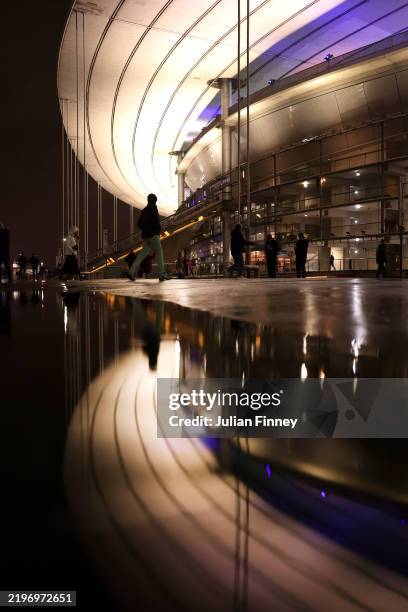 Reflection in a puddle of the stadium, as fans arrive prior to the Guinness Six Nations 2025 match between France and Wales at Stade de France on...