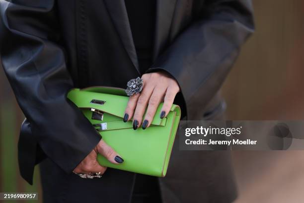 Corina Mihaila Larpin seen wearing Amiri black leather jacket, Ysl black wide pants and black top, Hermes green clutch bag, Stefere jewelry before...