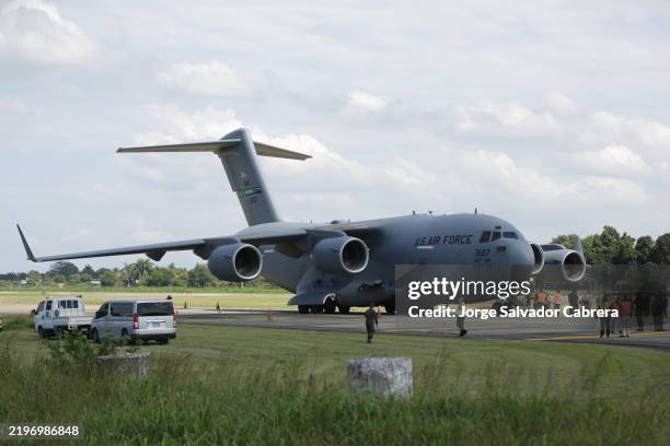 Air force flight carrying deported migrants by the US government arrive at Ramon Villeda Morales International Airport on January 31, 2025 in San...