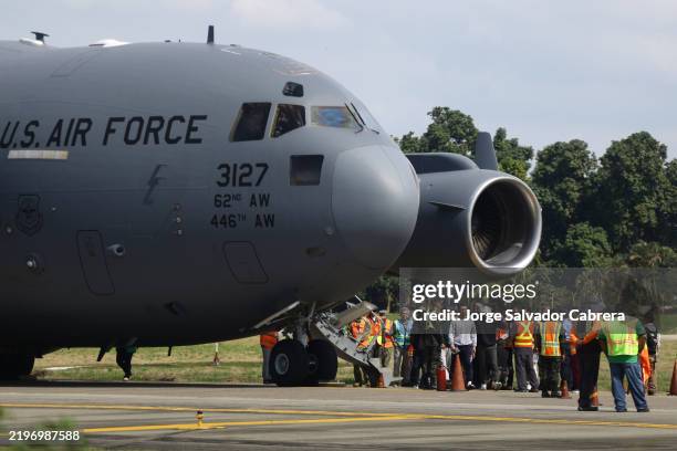 Air force flight carrying deported migrants by the US government arrive at Ramon Villeda Morales International Airport on January 31, 2025 in San...