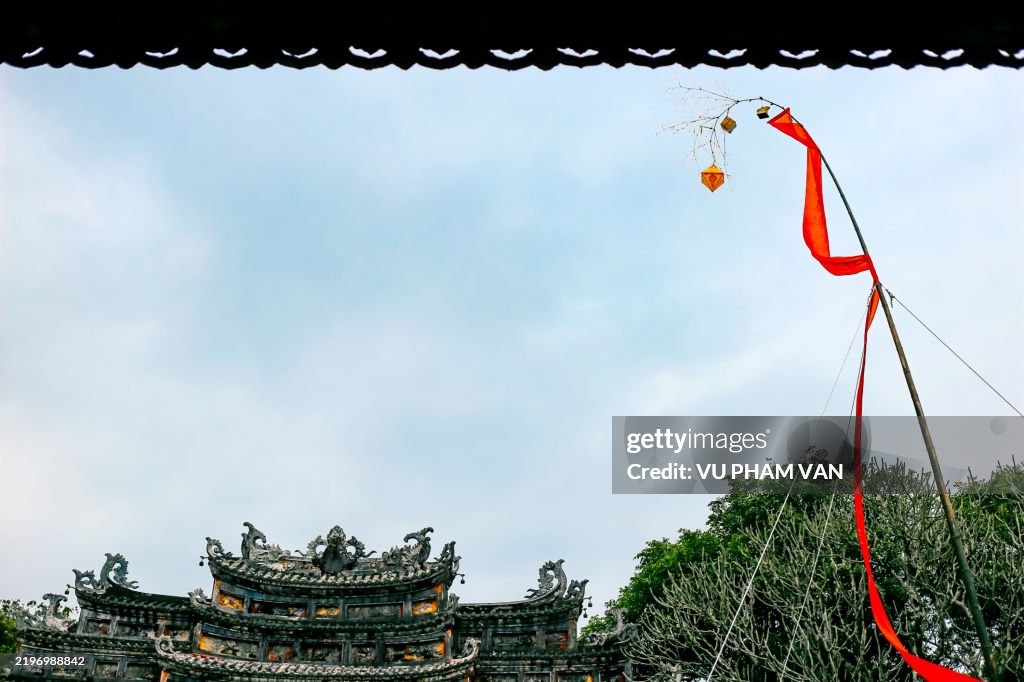 Tet pole standing high up sky in the imperial city of Hue, celebrating Vietnam lunar new year