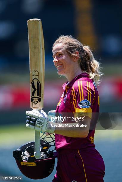Georgia Redmayne of the Fire ices her wrist as she walks off not out for 125 raises her bat to her team mates during the WNCL match between South...