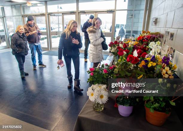 Mourners gather at a memorial at The International Skating Center of Connecticut after a moment of silence in memory of Flight AA5342, with a special...