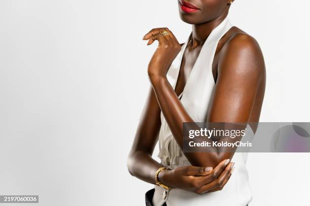 elegant young woman posing with hand on elbow and red lipstick - dark skin tone stock pictures, royalty-free photos & images