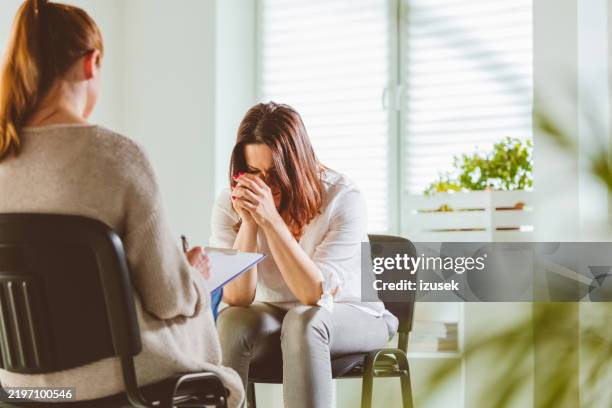 depressed female with psychotherapist - low self esteem stock pictures, royalty-free photos & images