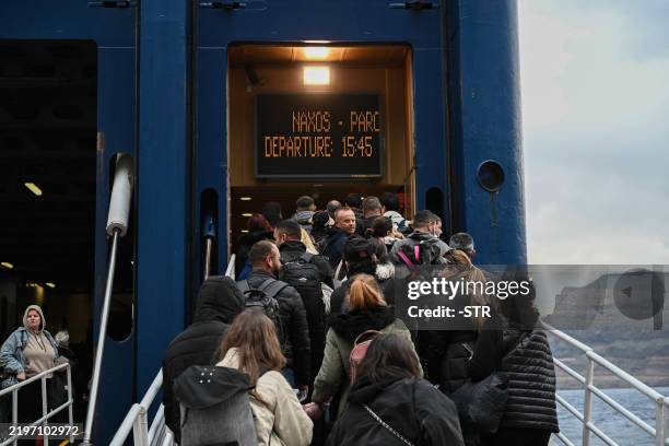 People embark a ferry as they leave in the wake of recurring earthquakes, on the Greek Island of Santorini on February 4, 2025. Fresh overnight...