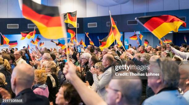 Supporters of the far-right Alternative for Germany wave German flags during an AfD election campaign rally with chancellor candidate Alice Weidel on...