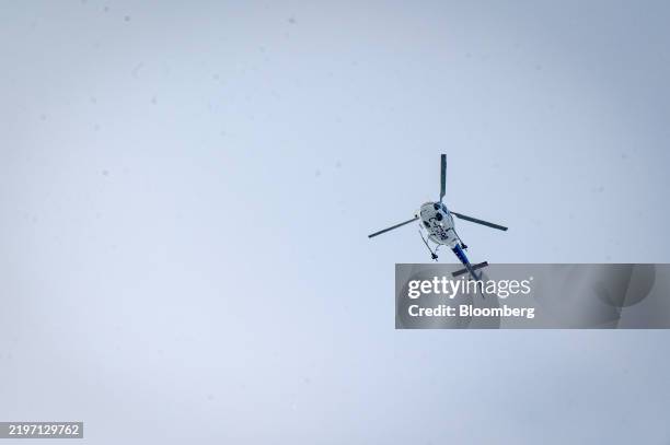 Royal Canadian Mounted Police helicopter flies over Roxham Road at the Canada-US border in St-Bernard-de-Lacolle, Quebec, Canada, on Tuesday, Feb. 4,...