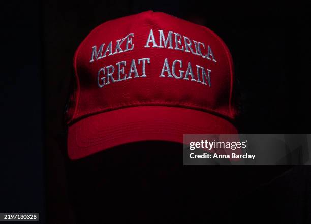 In this photo illustration a man wears a Make America Great Again baseball hat supporting US President Donald Trump, on February 1, 2025 in Sidmouth,...