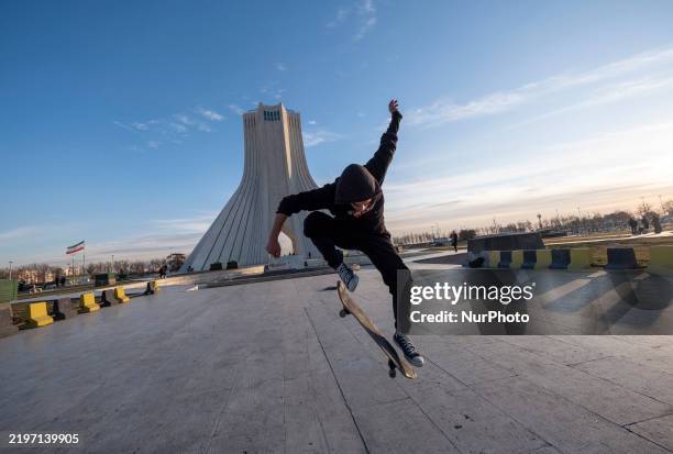 An Iranian young man performs with his skateboard at Azadi Square in Tehran, Iran, on February 4 on the eve of the 46th anniversary of the victory of...