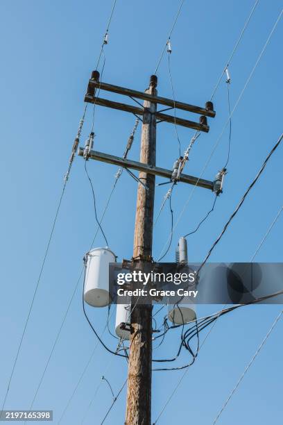 power lines on utility pole against blue sky - telephone pole stock pictures, royalty-free photos & images