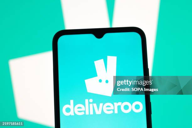 In this photo illustration, the Deliveroo logo is seen displayed on a smartphone screen.