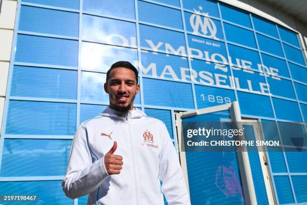 Marseille's Algerian forward Ismael Bennacer gives a thumbs up as he poses during his presentation as a new player of Olympique de Marseille football...