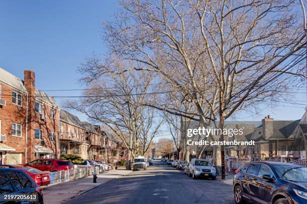 view up a street with residential buildings - queens new york city stock pictures, royalty-free photos & images