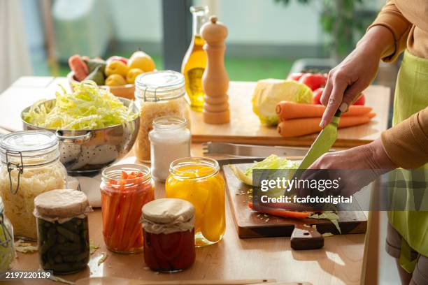 close up of woman's hands chopping fresh organic vegetables. pickling healthy vegetables at home - i was turning into a vegetable stock pictures, royalty-free photos & images