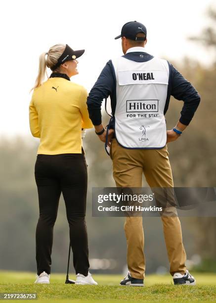 Blair O'Neal and her caddie and husband, Jeff Keiser, looks on from