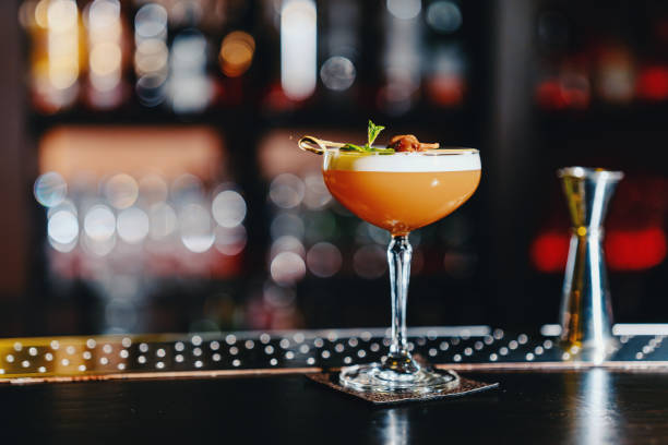 refreshing drink on a bar counter - orange cocktail stock pictures, royalty-free photos & images