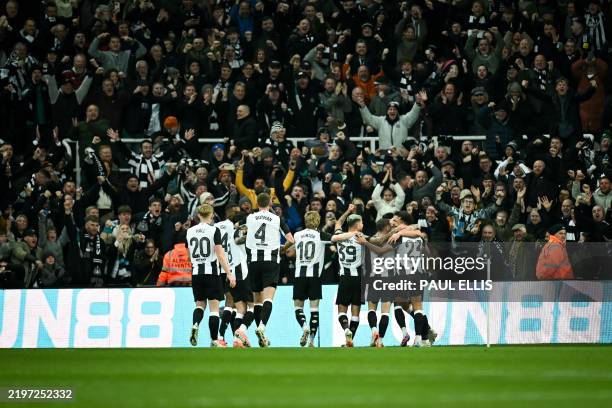 Newcastle United's English midfielder Jacob Murphy celebrates with teammates after scoring his team first goal during the English League Cup...