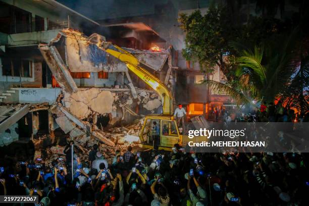 Protesters use an excavator to demolish the Bangabandhu Memorial Museum, the former residence of Sheikh Mujibur Rahman father of the former Prime...