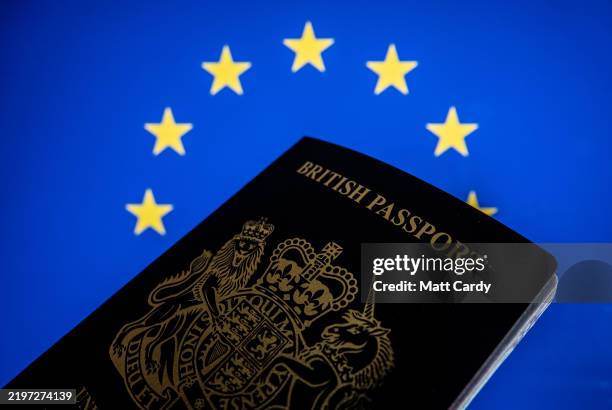 In this photo illustration, a man holds a post-Brexit United Kingdom issued passport on February 2, 2025 in Bath, England. Since leaving the European...