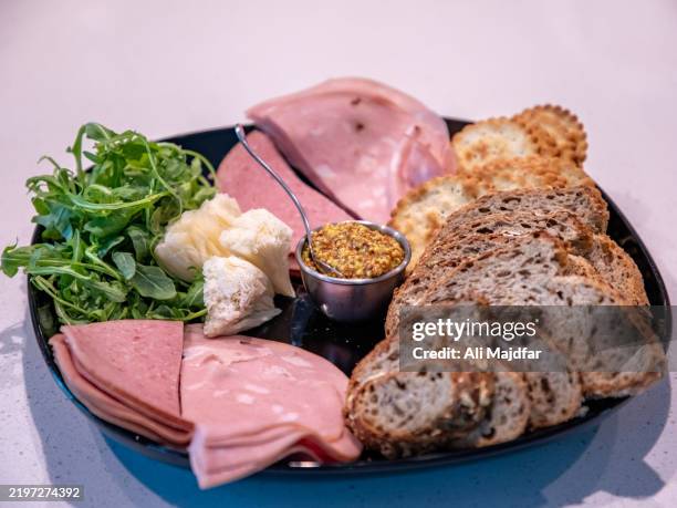 cold cut and tête de moine rosettes cheese appetizer dish - mortadella stock pictures, royalty-free photos & images