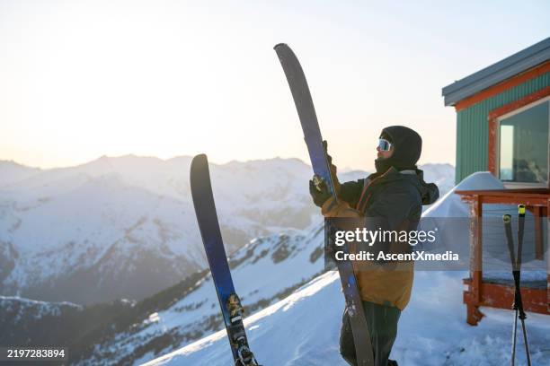 skitourengeher bereitet sich auf die bergabfahrt vor - skifahrer stock-fotos und bilder