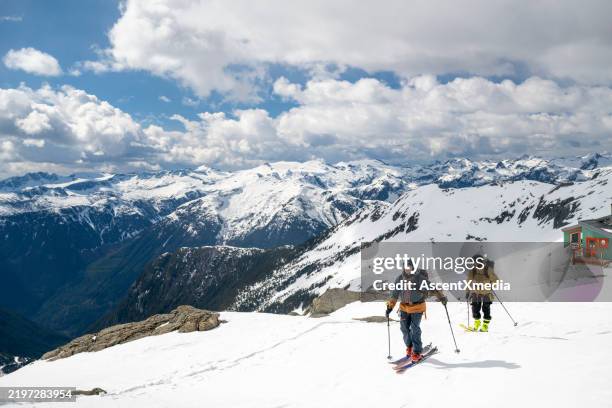 backcountry skiers ascend snowcapped mountain - off piste stock pictures, royalty-free photos & images