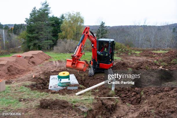 installing a septic system - grävmaskin bildbanksfoton och bilder