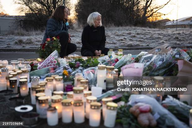 People light candles at a makeshift vigil near the adult education center Campus Risbergska school in Orebro, Sweden, on February 6, 2025 two days...