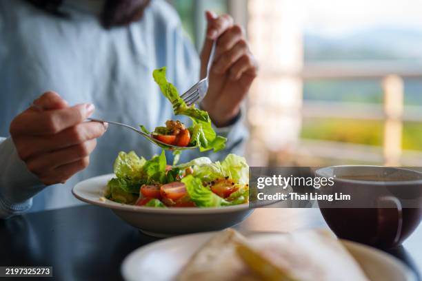 person eating fresh salad with coffee at a cozy home - eating salad stock pictures, royalty-free photos & images