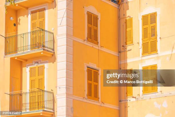 yellow residential apartment building facade, camogli, italy - shutter stock pictures, royalty-free photos & images
