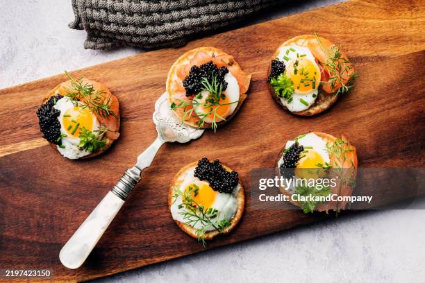 blinis with quail eggs smoked salmon and caviar - serving size stock pictures, royalty-free photos & images