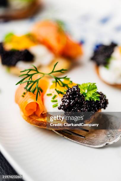 blini with quail egg smoked salmon and caviar - serving size stock pictures, royalty-free photos & images