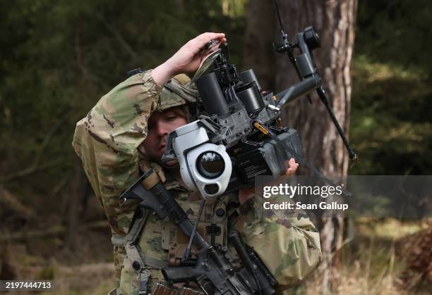 Soldier of a LUAS platoon of the U.S. Army 3rd Brigade, 10th Mountain Division, carries a Anduril Ghost-X helicopter surveillance drone during the...