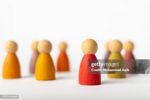 wooden figurine representing diversity and the concept of separation - menschliche darstellung stock-fotos und bilder