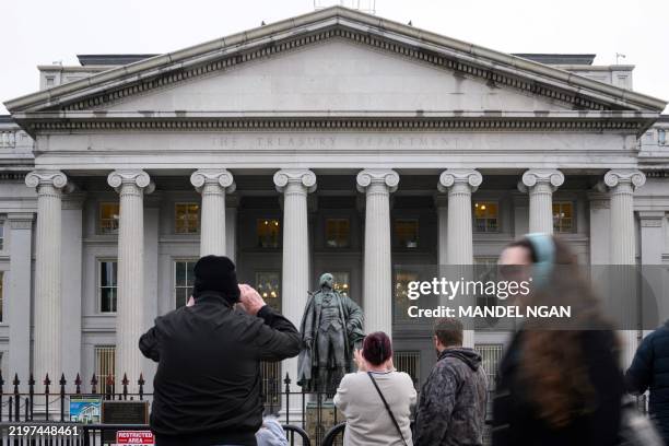 People take pictures of the US Treasury in Washington, DC, on February 6, 2025. Opponents to US President Donald Trump say he allowed Elon Musk --...