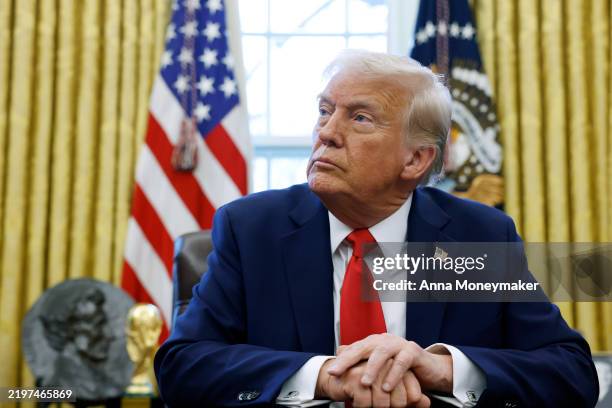 President Donald Trump speaks to reporters in the Oval Office of the White House on February 03, 2025 in Washington, DC. After signing a series of...