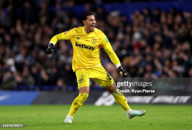 Alphonse Areola of West Ham United celebrates his team's first goal, scored by teammate Jarrod Bowen during the Premier League match between Chelsea...