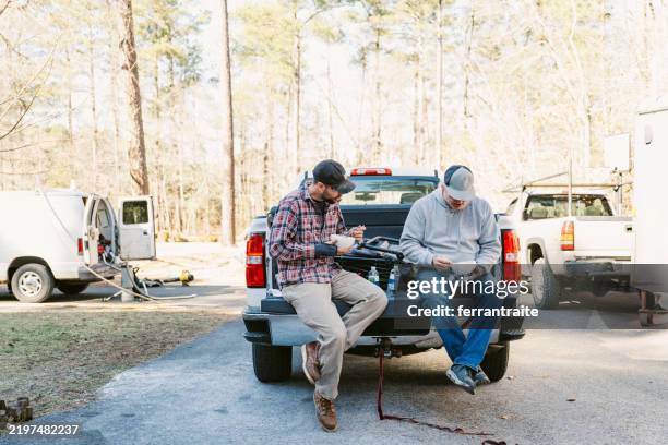 construction workers sitting on tailgate during lunch break - tail gate stock pictures, royalty-free photos & images