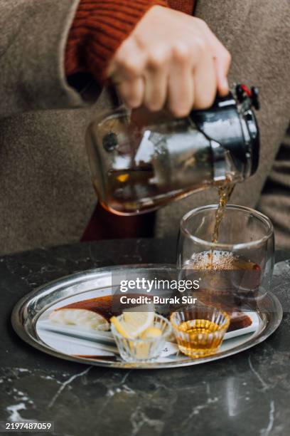 brewing herbal tea and adding honey - japanese tea cafe stock pictures, royalty-free photos & images