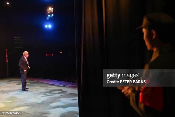 This photo taken on January 31, 2025 shows Hong Kong actor Loong Koon-tin made up as US President Donald Trump on stage during a rehearsal of the...