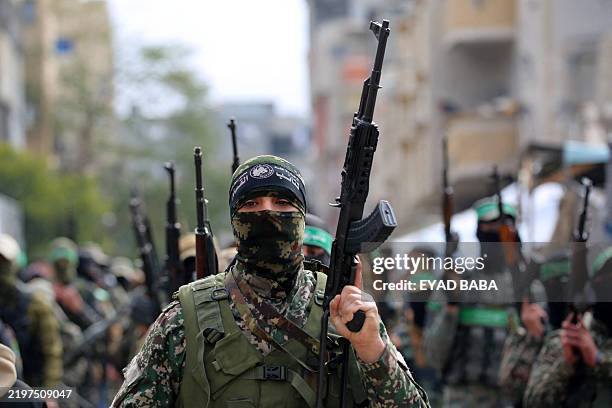 Palestinian fighters from the Ezzedine al-Qassam Brigades, the armed wing of Hamas, take part in the funeral procession of Marwan Issa, a top Hamas...