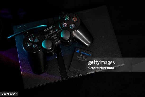 Sony PlayStation 2 slim video game console with its controller and a memory card.