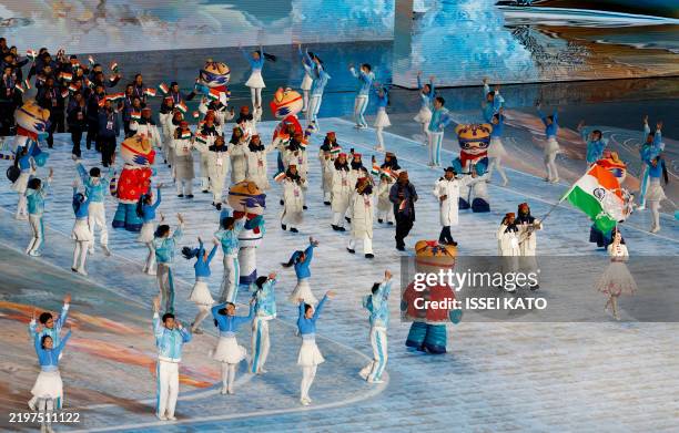 India's flag bearers lead their contingent during the parade of athletes at the opening ceremony of the Harbin 2025 Asian Winter Games in Harbin,...