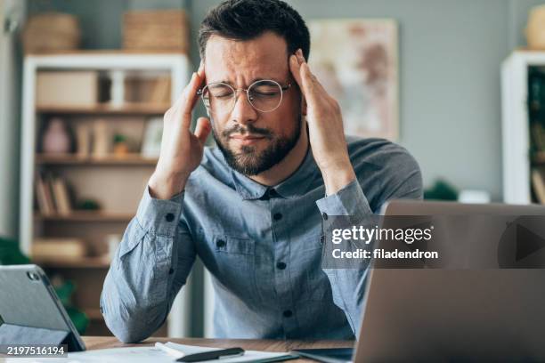 stressed home worker - banging-your-head-against-a-wall stock pictures, royalty-free photos & images
