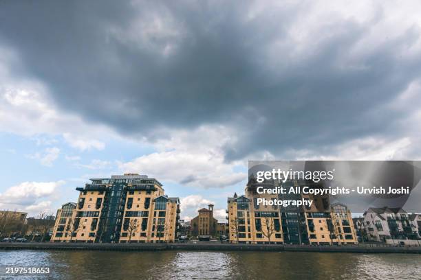 symmetrical modern buildings by river thames, london - 2016 stock pictures, royalty-free photos & images