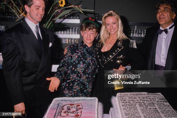 American actor David Faustino, wearing a 'The Hunt for Red October' baseball cap and a multicoloured shirt, and American actress Hope Marie Carlton,...