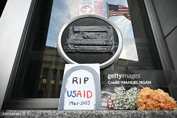 Tributes are placed beneath the covered seal of the US Agency for International Development at their headquarters in Washington, DC, on February 7,...